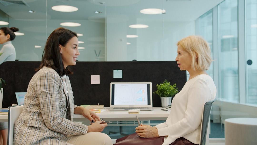 Two colleagues having an in-depth conversation at their desk